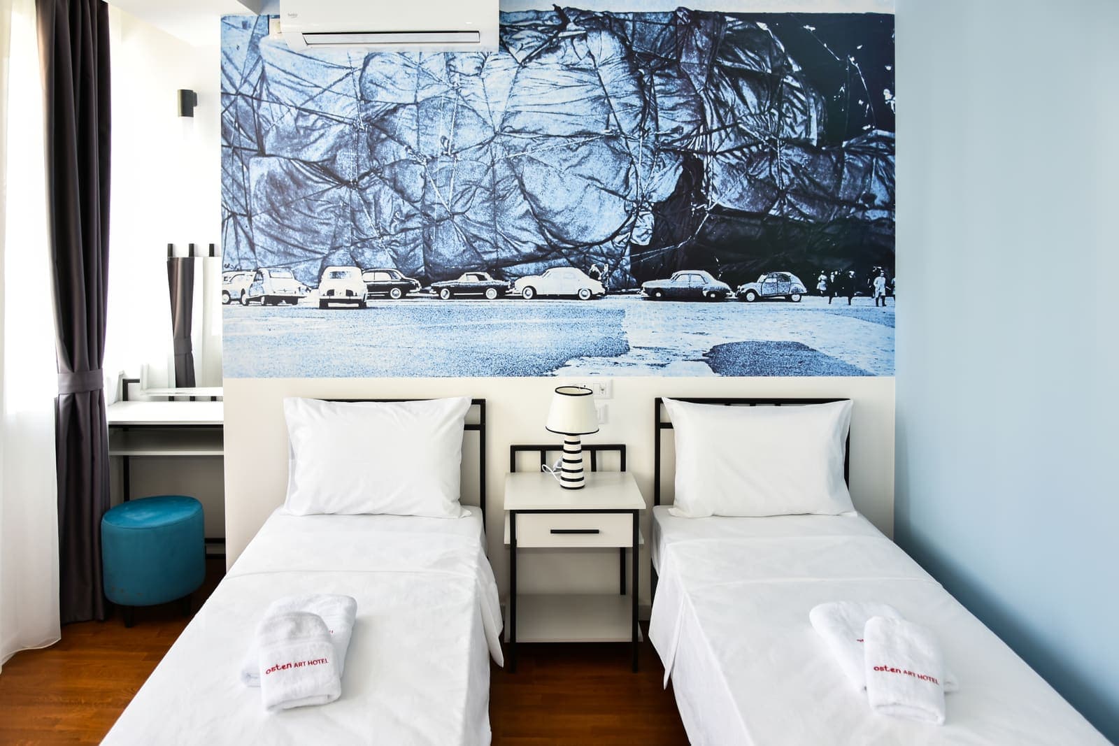 Twin beds under the winter mural — Room 3